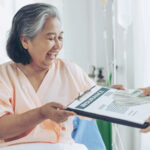 elderly patients injury woman patient s bed hospital holding us dollar bills feel happy from getting insurance money from insurance companies