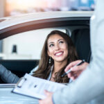 happy customer buying brand new car local car dealership